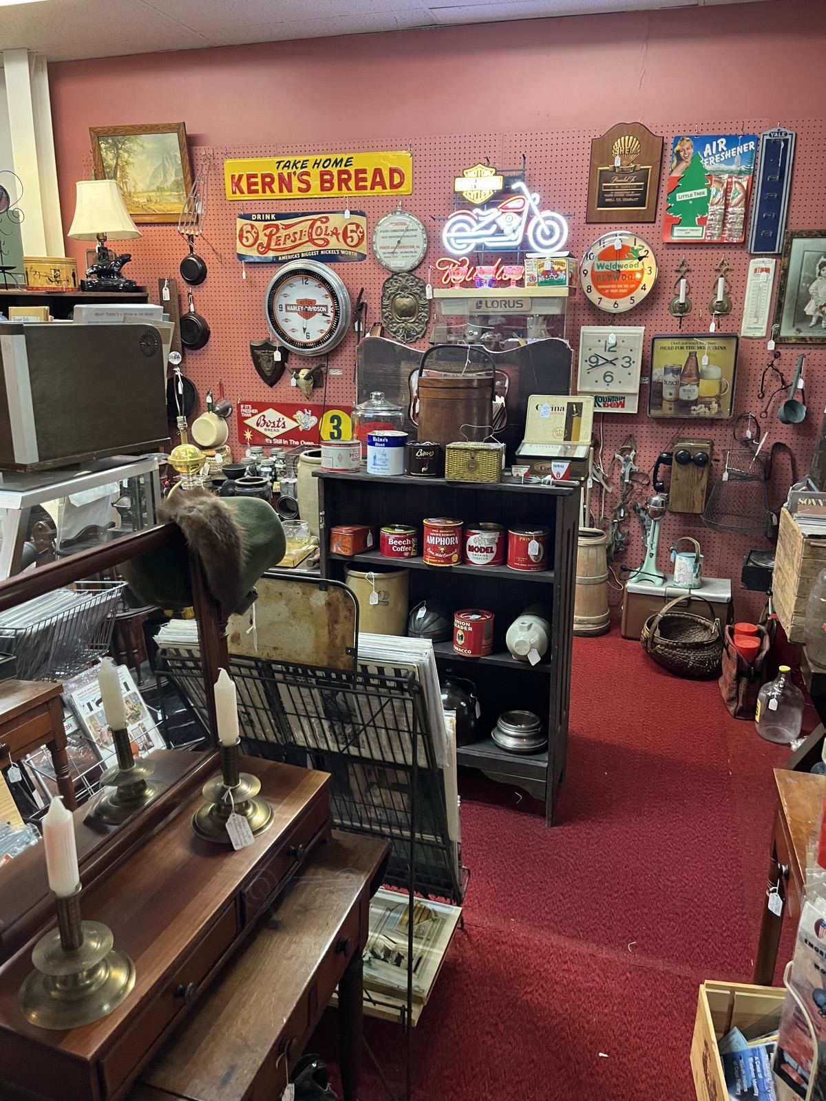 Wall of vintage advertising signs and tins
