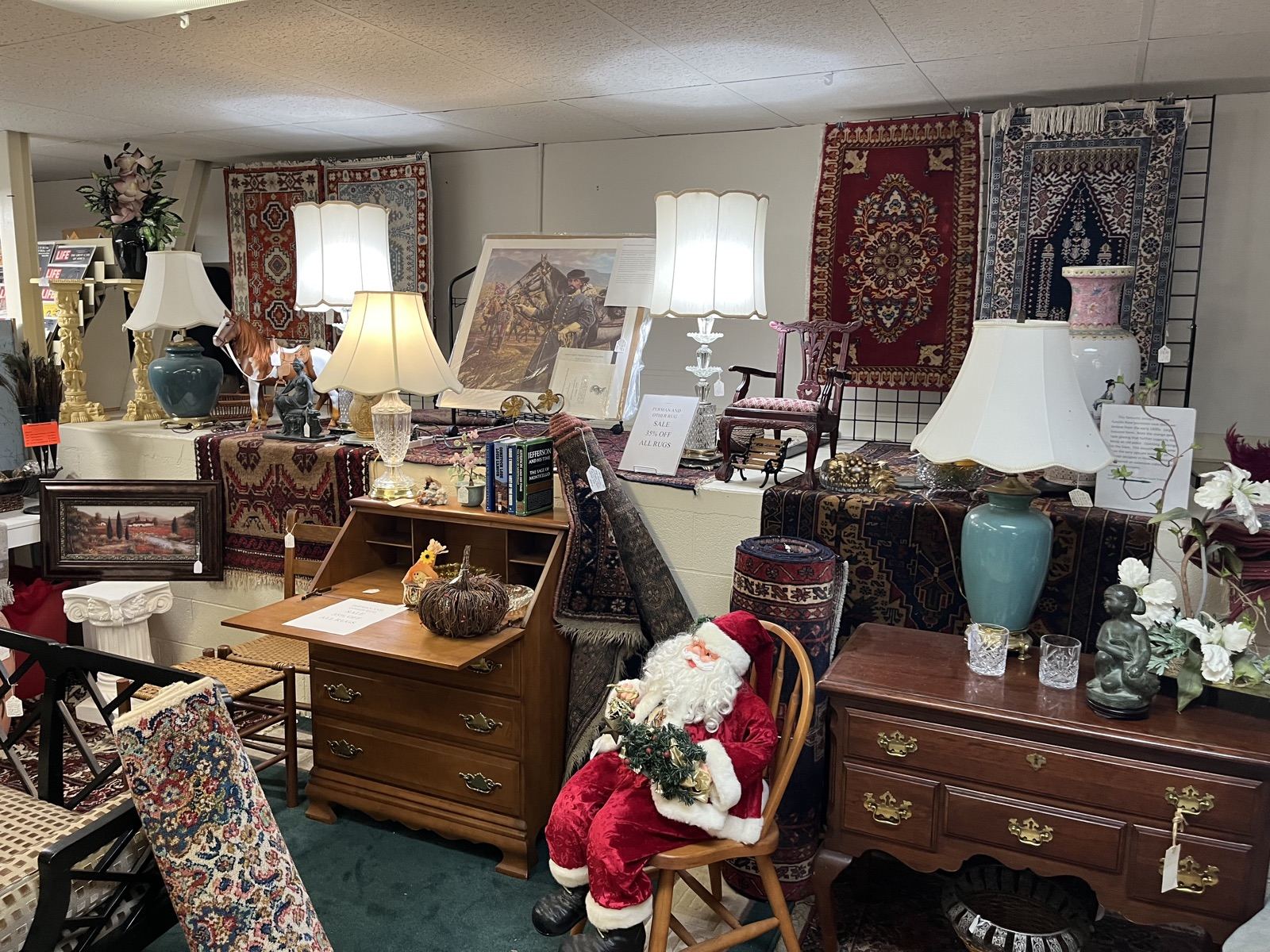 Lamps, a writing desk and Oriental rugs hung on the wall
